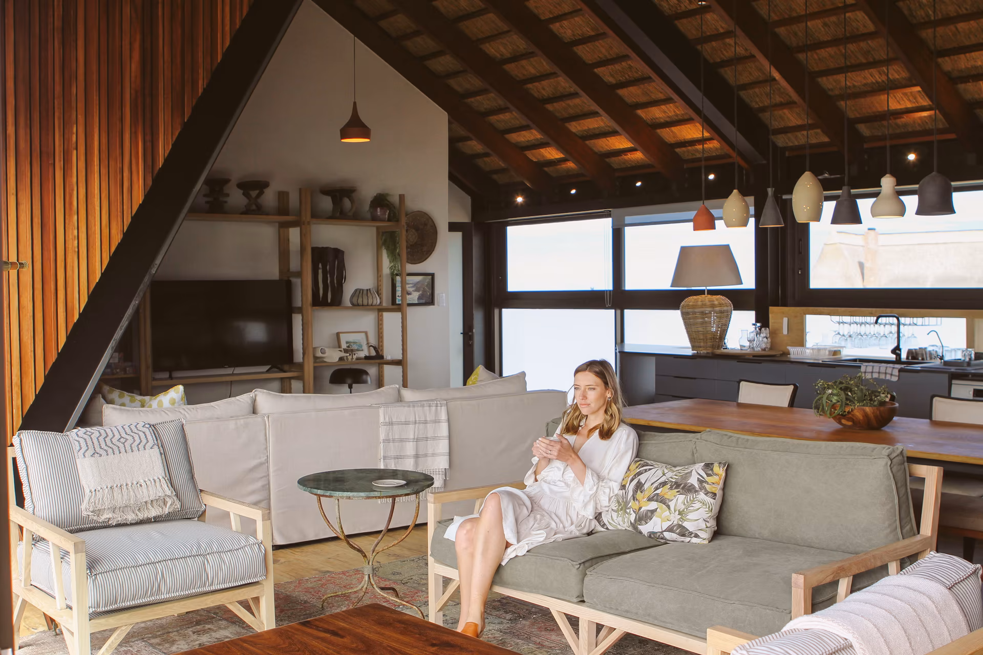 Casa Caro's open-plan living room beneath the high timber and thatch roof