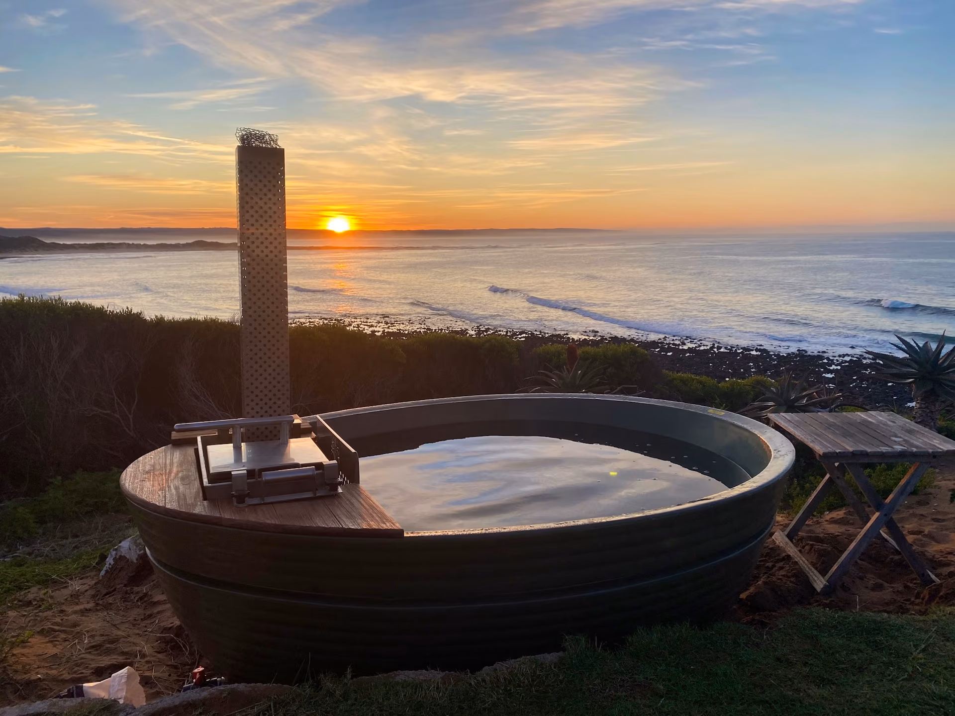 Casa Caro's wood-fired hot tub overlooking an Atlantic sunset