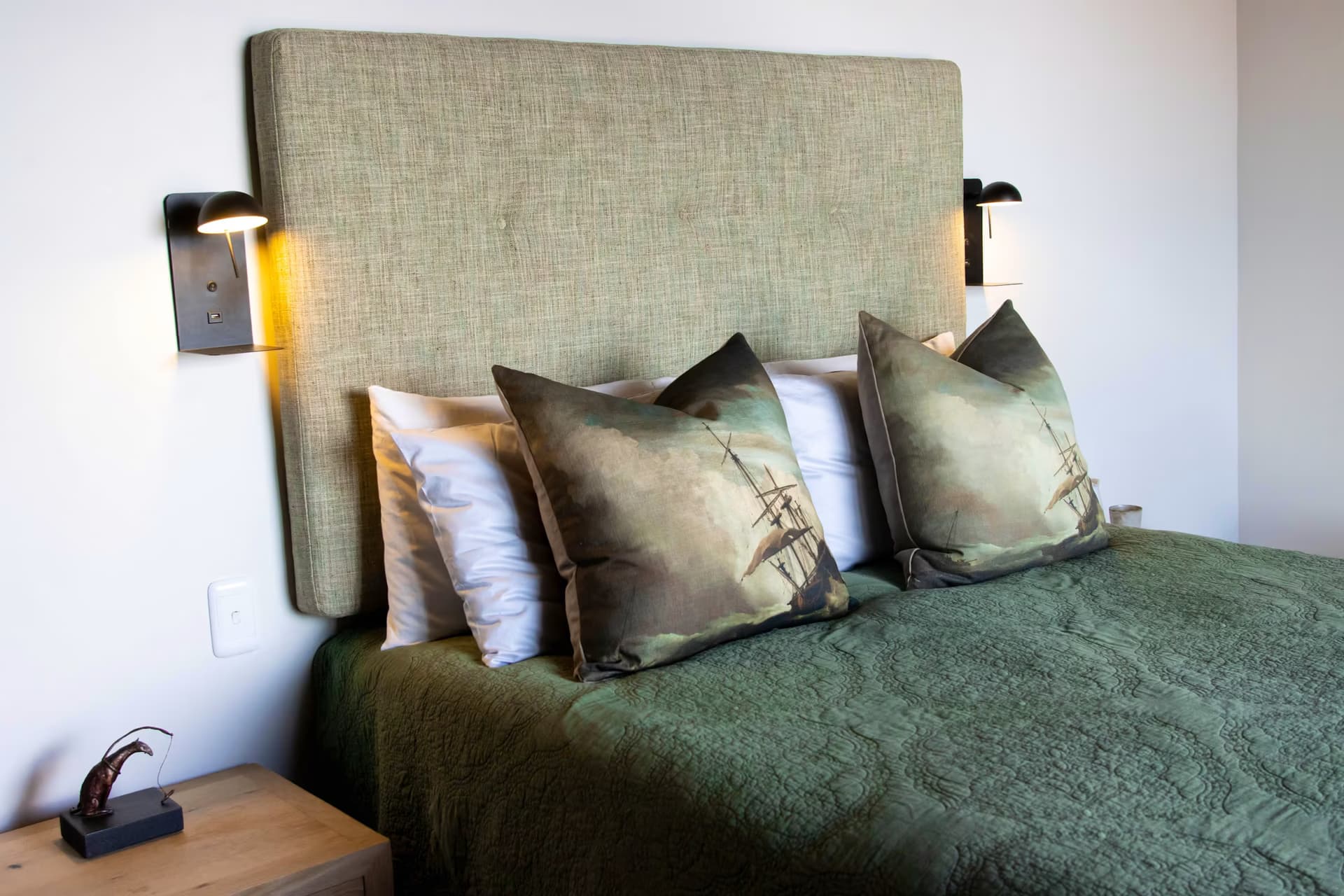 A calm green queen bedroom at Casa Caro