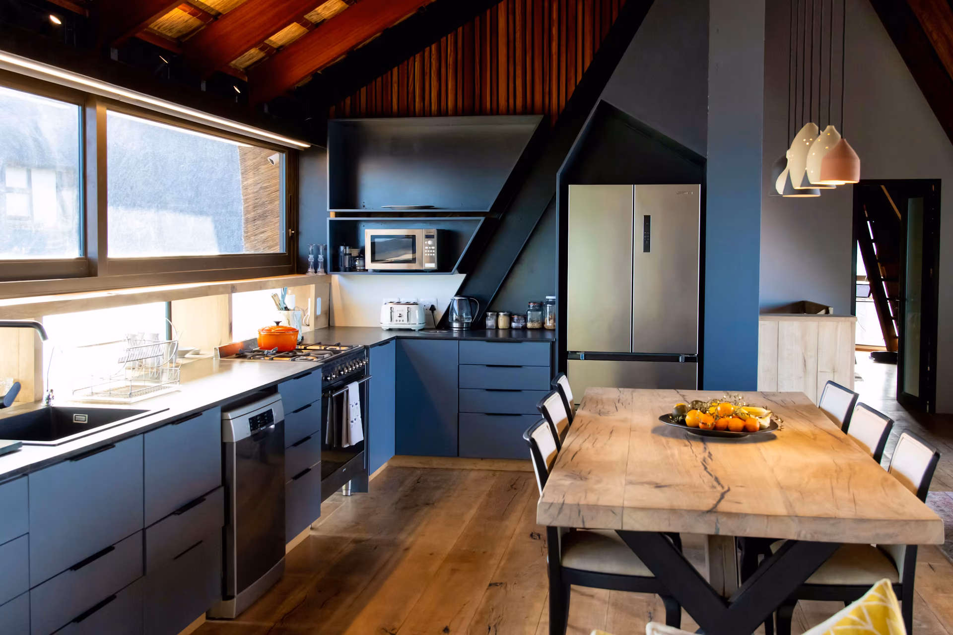 Casa Caro's dark blue kitchen and ten-seat timber dining table